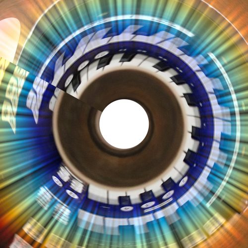 Tie-Dyed Round Organ with a Circled Donut in the Middle, with Multi-Colored Lazers, Brown, Green, Blue, White, Red from Another Dimension, Space, and Time